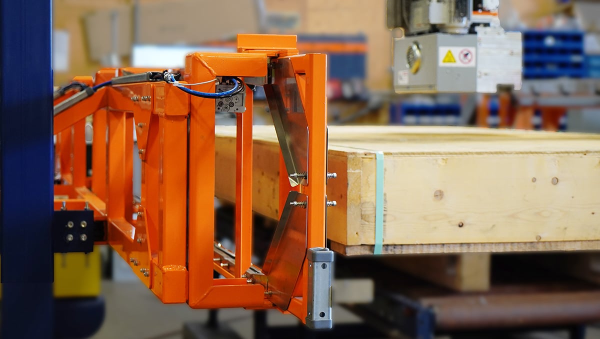 Custom-engineered strapping machine finished strapping a wooden crate