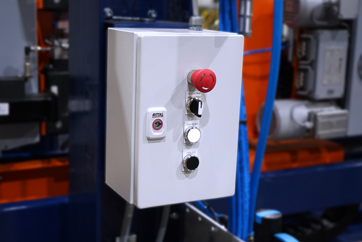 A stop button assembly on a strapping machine